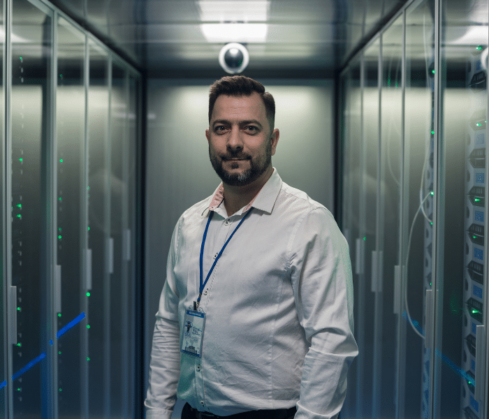 Engineer monitoring servers 24/7 for high availability and security